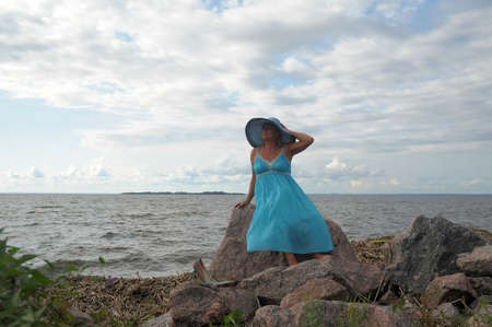 woman sitting in a dress on the bankの写真素材