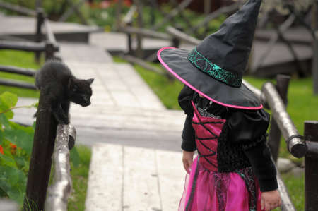little witch with a black kittenの写真素材