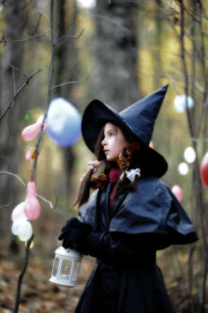 Small girl in a witch halloween costumeの写真素材