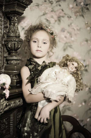 little girl with a doll in hands  
の写真素材