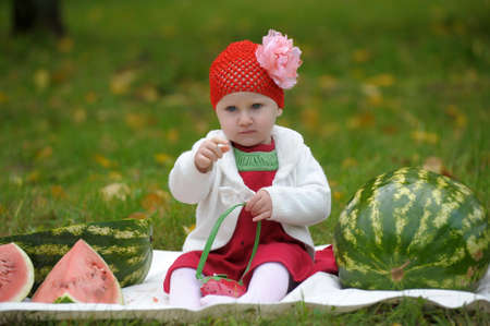 The little girl with a water-melonの写真素材