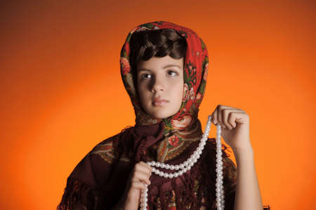 Girl with a scythe in Russian shawlの写真素材