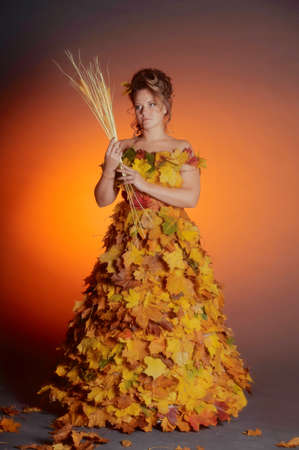 woman with a dress made of autumn leavesの写真素材