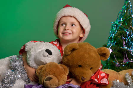 boy in the Christmas hat with toy bearの写真素材