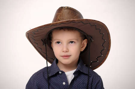 Happy young boy with a cowboy hatの写真素材