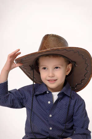 Happy young boy with a cowboy hatの写真素材