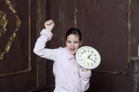 girl holding big clock 