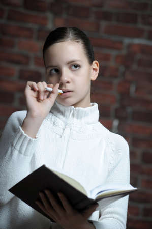 Girl writing in notebookの写真素材