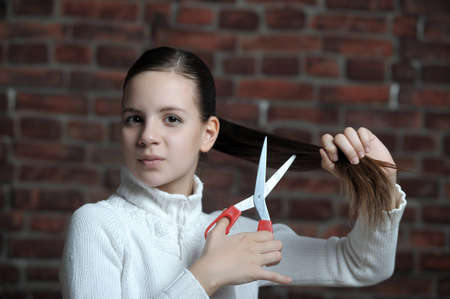 teen girl is going to cut your hairの写真素材