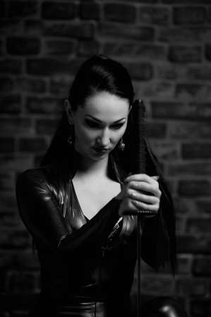 girl in a blue suit with a fitting close katana in handsの写真素材