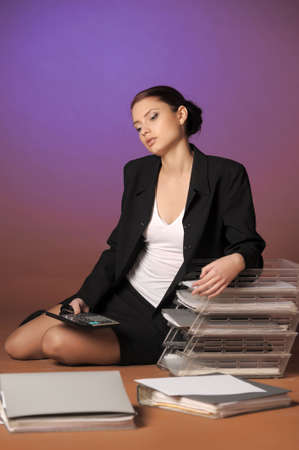 Young secretary or businesswoman in suit with notebook 