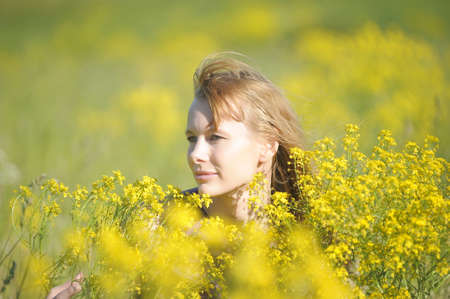 young woman in a field of yellow flowers