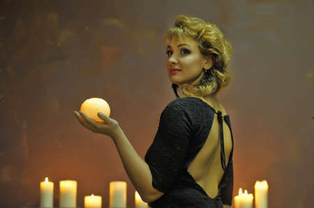 Studio picture of a young woman with candles 