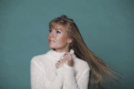 beautiful blonde in a white sweaterの写真素材