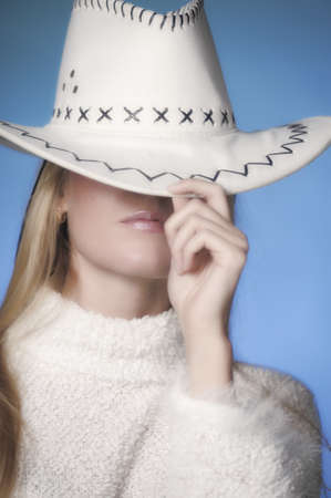 Girl wearing cowboy hat in the studio