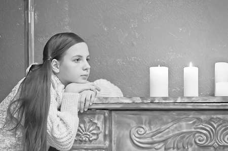 The girl the teenager at a fireplace with candlesの写真素材