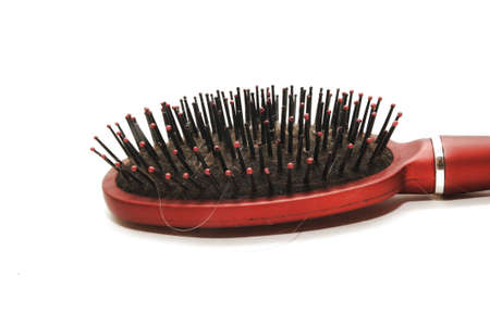 Close-up of a hairbrush with lost hair in itの写真素材