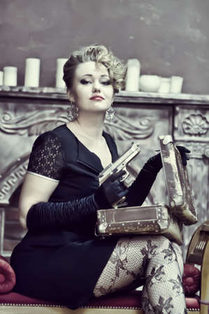 Blonde holding a gunの写真素材