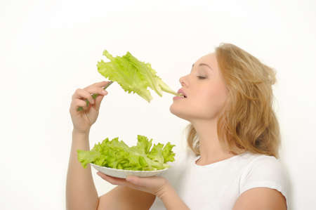 Young beauty girl with green lettuce の写真素材