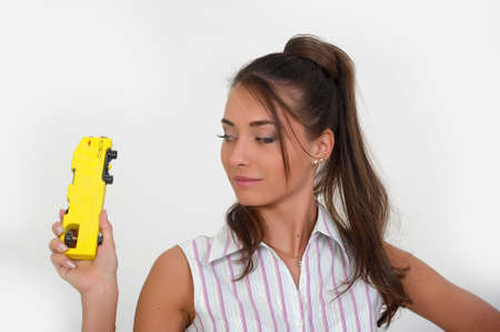 Closeup of a pretty girl checking spirit level indication