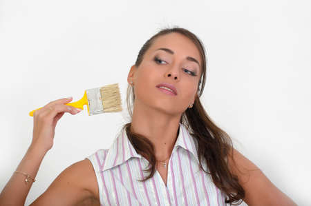  Image of a beautiful girl on white, holding paint brush