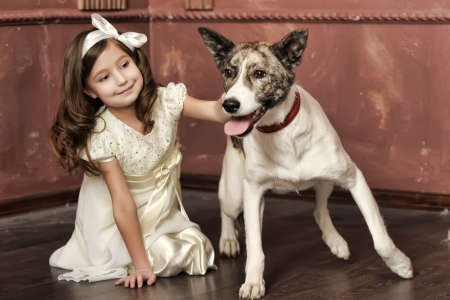 Vintage portrait of a little girl with dogの写真素材