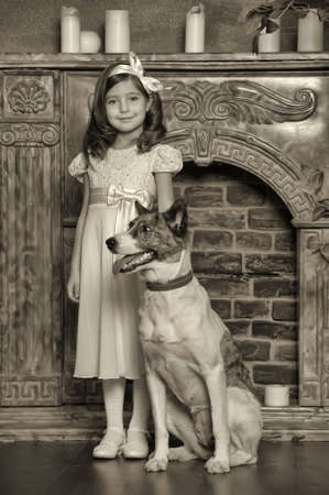 Vintage portrait of a little girl with dogの写真素材