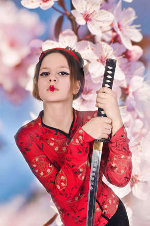 A girl handling a long samurai sword の写真素材