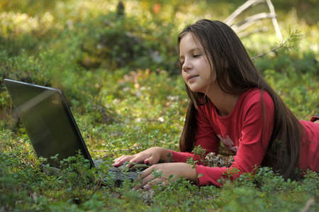 girl with laptop in the woodsの写真素材