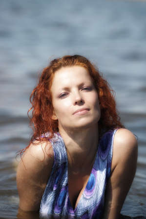 young woman in a dress in the waterの写真素材
