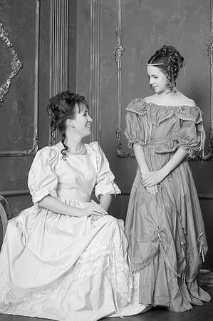 Two ladies in medieval dresses, black and white photoの写真素材
