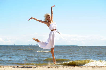 Girl in white dress on beachの写真素材