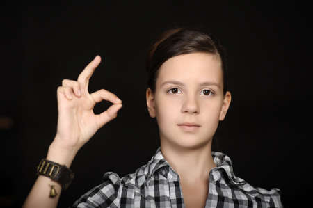 Lovely teenage girl showing ok sign の写真素材