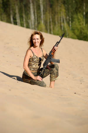 Armed beautiful young woman の写真素材