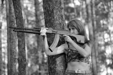 Armed beautiful young woman の写真素材