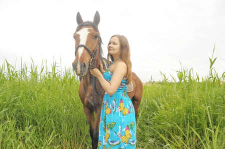 Young girl in dress with  horseの写真素材