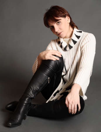 young woman in a sweater and bootsの写真素材