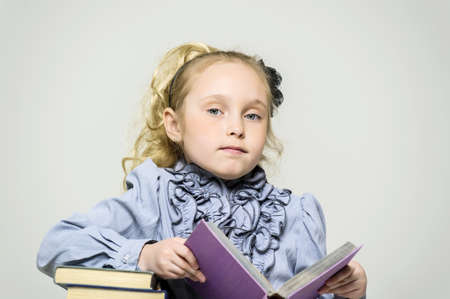 girl schoolgirl with a stack of booksの写真素材