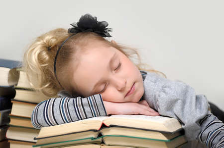 Girl asleep on the books の写真素材
