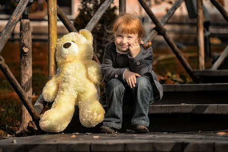Child with toy bear cubの写真素材