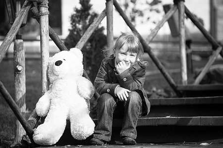 Child with toy bear cubの写真素材