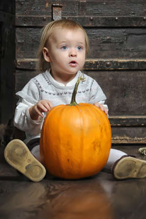 Halloween baby with pumpkinsの写真素材