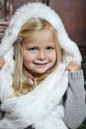 little girl in white fur bonnetの写真素材