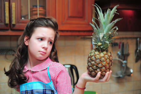 Girl with a pineapple in his handsの写真素材