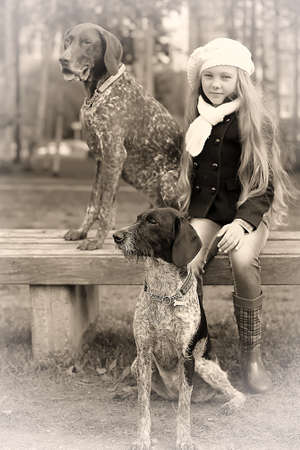 girl in the park, and two dogs