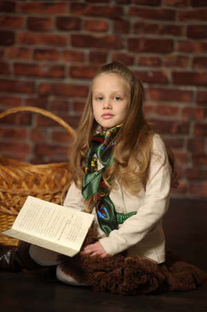 girl on the floor with a bookの写真素材