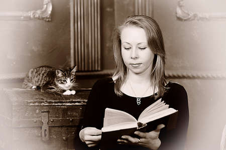 woman with a book and a kitten