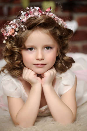 Beautiful little girl in wreath of pink flowersの写真素材