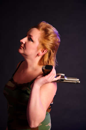 middle-aged woman with a gunの写真素材