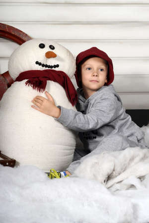 boy with a snowmanの写真素材